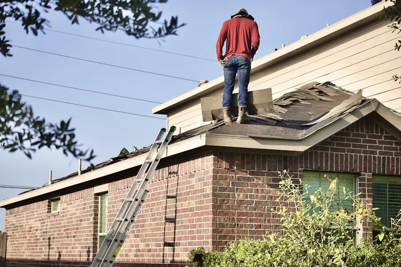 Professional roofer working on a residential roof in Preston Royal Northwest